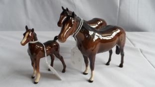 TWO ROYAL DOULTON HORSES BOTH WITH WHITE SOCKS AND NOSE FLASH TOGETHER WITH A BESWICK FOAL (TAIL