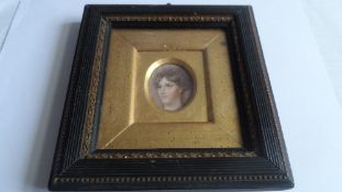 A LATE 18th / EARLY 19th CENTURY PORTRAIT MINIATURE OF A TITIAN HAIRED YOUNG LADY IN AN EBONISED AND