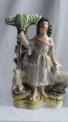 A STAFFORDSHIRE FLATBACK FIGURE DEPICTING A RAVEN HAIRED SHEPHERDESS, APPROX 19 cms