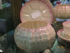 A PART IRISH TRIDACNA PATTERN BELLEEK TEA SET COMPRISING OF A MILK JUG, SUGAR BOWL, THREE CUPS AND