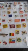 A LARGE AND INTERESTING COLLECTION OF WWI AND WWII FUND RAISING FLAGS AND TIN PLATE BADGES;