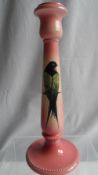 A CANDLE STICK BY WILLIAM AULT, DECORATED IN GRADUATED PINK GROUND WITH A POLYCHROME " SWIFT " IN