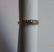 A LADY`S 18ct YELLOW AND WHITE GOLD DIAMOND RING SET WITH FIVE STONES AT 18 PTS. EACH - 90 PTS.