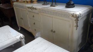 A LARGE CONTEMPORY MARBLE TOPPED CREAM SIDEBOARD HAVING BRASS EMBELLISHMENTS, FITTED WITH THREE