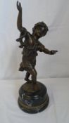A BRONZE FIGURE OF A CHILD AT PLAY ON A BLACK STEPPED MARBLE PLINTH. 38cms H. MARKED C C