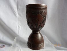 A HARDWOOD AFRICAN CARVED GOBLET DEPICTING A RHINO AND ELEPHANT
