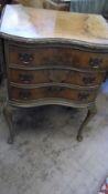 A SERPENTINE FRONT WALNUT AND MAHOGANY DROP LEAF CHEST OF DRAWERS