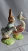 TWO GOLD BACK STAMPED AND SIGNED BESWICK BEATRIX POTTER FIGURES NAMELY `PETER RABBIT` AND `JEMIMAH