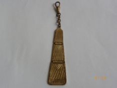 A BRASS FOLD OUT MASONIC STYLE CHAIN FOB IN THE FORM OF AN APRON