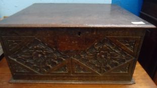 A 17TH CENTURY OAK TABLE TOP BIBLE BOX, THE FRONT PANEL CARVED WITH FLORAL DESIGN WITHIN TWO DIAMOND