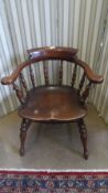 AN ANTIQUE MAHOGANY SPINDLE BACK ELBOW / SMOKER`S CHAIR ON TURNED LEGS AND STRETCHERS