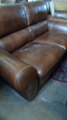 A BROWN LEATHER TWO SEATER SOFA MADE IN ITALY BY SOFATELLA