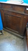 A VICTORIAN OAK CORNER CUPBOARD HAVING A PANELLED DOOR ENCLOSING THREE SHELVES WITH A SINGLE