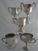 Miscellaneous collection of five solid silver Regimental Trophies. The twin handled trophies include