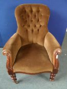 A Victorian Mahogany Button Back Chair, the drawing room chair having carved front arm supports on