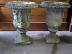 A Pair of Stone Garden Planters. The planters being circular and decorated with greco / roman