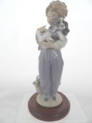A Lladro Figure " Boy With Poorly Dog " ( Perdito Convalecionte ). An event and privileged piece,