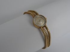 A Lady`s Movado Watch A yellow 9 ct gold Movado dress watch on a 9 ct gold ribbon and bar