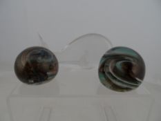 Two contempory paperweights, approximately 7 cms in height together with a glass paper weight of