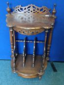 Reproduction intricately carved Canterbury having turned supports and shelf with four magazine