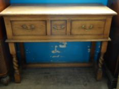 A Bespoke Oak Sideboard. The sideboard having three drawers and being supported on turned and square