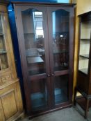 A Mahogany Display Cabinet. The cabinet having glazed doors with five glass shelves and one mahogany