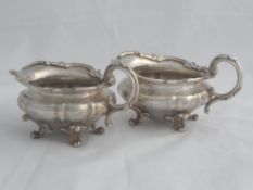 A pair of solid silver William IV style Sauce Boats. The Regimental sauce boats on scroll feet.