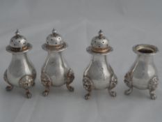 A set of four solid silver Regimental William IV style Pepper Pots. The peppers inscribed with