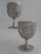 A pair of Indian silver Regimental Presentation Goblets. The ornate goblets depict exotic birds