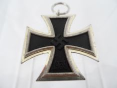 A German Third Reich Period Iron Cross. The cross being second class, marked s on the suspension