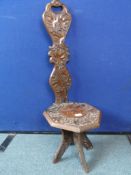 An Antique Oak Child`s Chair, The chair being highly decorated with carved foliage, supported on
