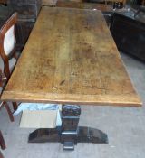 An Antique Oak Dining Table. The dining table being on two ornately carved bulbous supports having