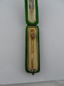 An Edwardian 9ct hallmarked gold Tie Pin, the tie pin having a diamond chip to centre, beaded edge