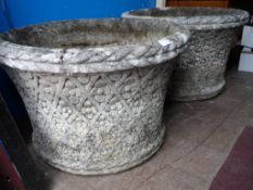 A Pair of Garden Planters. The decorative stone planters being circular. Approx. 63 cms diameter.