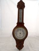 A Barometer, the case being mahogany effect, approx. 60 cms in length.