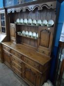 A Large Bespoke Oak Welsh Dresser. The top having open shelves with a cupboard and a drawer under to