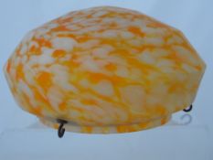 A Ceiling Light Shade. The Art Deco shade being orange marbled in colour. Approx. 32 cms diameter.