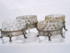 Four silver Regimental Table Salts. The salts with original cut glass liners each base standing on