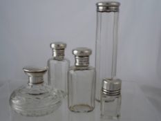 Silver topped Dressing Table Bottles. A collection of five cut glass silver topped scent bottles. (