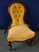 A Victorian Button Back Drawing Room Chair. The mahogany button back chair being having carved