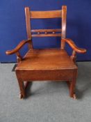 An Antique Oak Rocking Chair, the antique Georgian style chair having carved spheres to the back