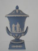 A Blue Wedgwood Jasper Ware Urn. The two handled lidded urn having a classical frieze. Approx. 29