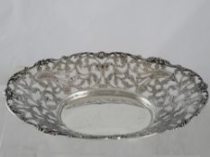 Oval Fruit Basket. The continental white metal fruit bowl features floral and scroll pierced