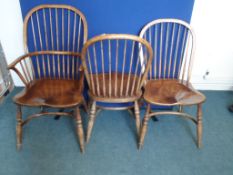 A Set of Six Elm Dining Chairs. The set of spindle back chairs comprises four chairs and two