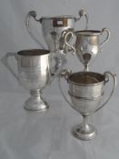 Miscellaneous collection of four solid silver Regimental Trophies. The twin handled trophies include