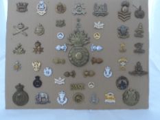 A Collection of Military Badges. The collection mounted on a card incl. royal marine artillery
