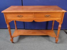 An Edwardian Oak Washstand. The washstand having two drawers and an under shelf on turned legs and