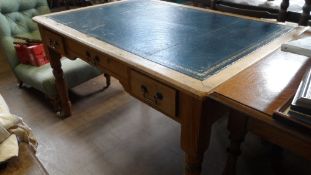 A BLUE LEATHER TOPPED RECLAIMED PINE WRITING TABLE FITTED WITH THREE DRAWERS ON TURNED LEGS ,