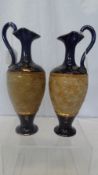 A PAIR OF ROYAL DOULTON EWER, `SLATER PATENT` BOTH HAVING CENTRAL BAND ON TEXTURED GILT GROUND