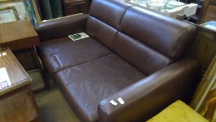 A BROWN LEATHER TWO SEATER SOFA BED